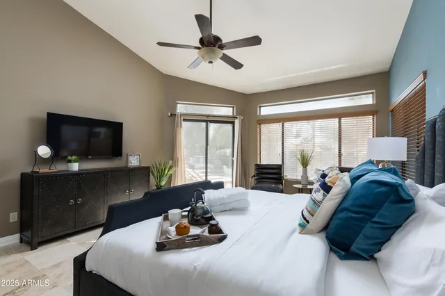 a living room with furniture a flat screen tv and a large window
