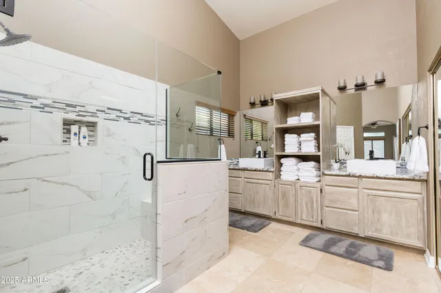 a kitchen with stainless steel appliances kitchen island granite countertop a refrigerator and a sink