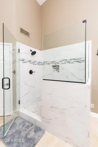 a bathroom with a granite countertop shower and a sink
