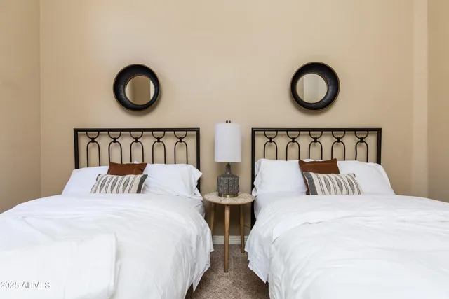 a bedroom with two large bed and a bed