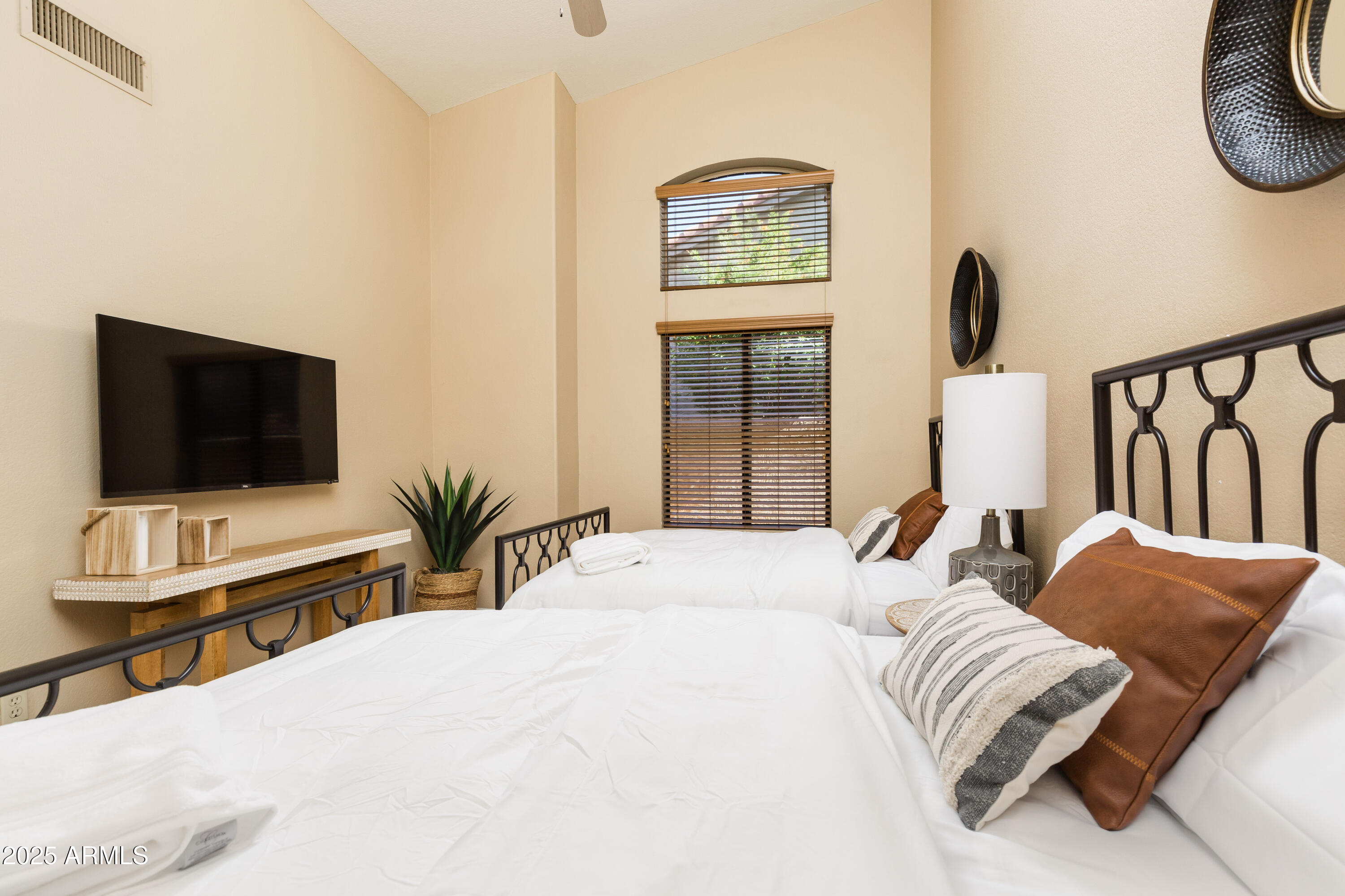 5821 East Aire Libre Avenue Scottsdale, AZ 85254 - Photo 20 of 35 a bedroom with a bed and a flat screen tv