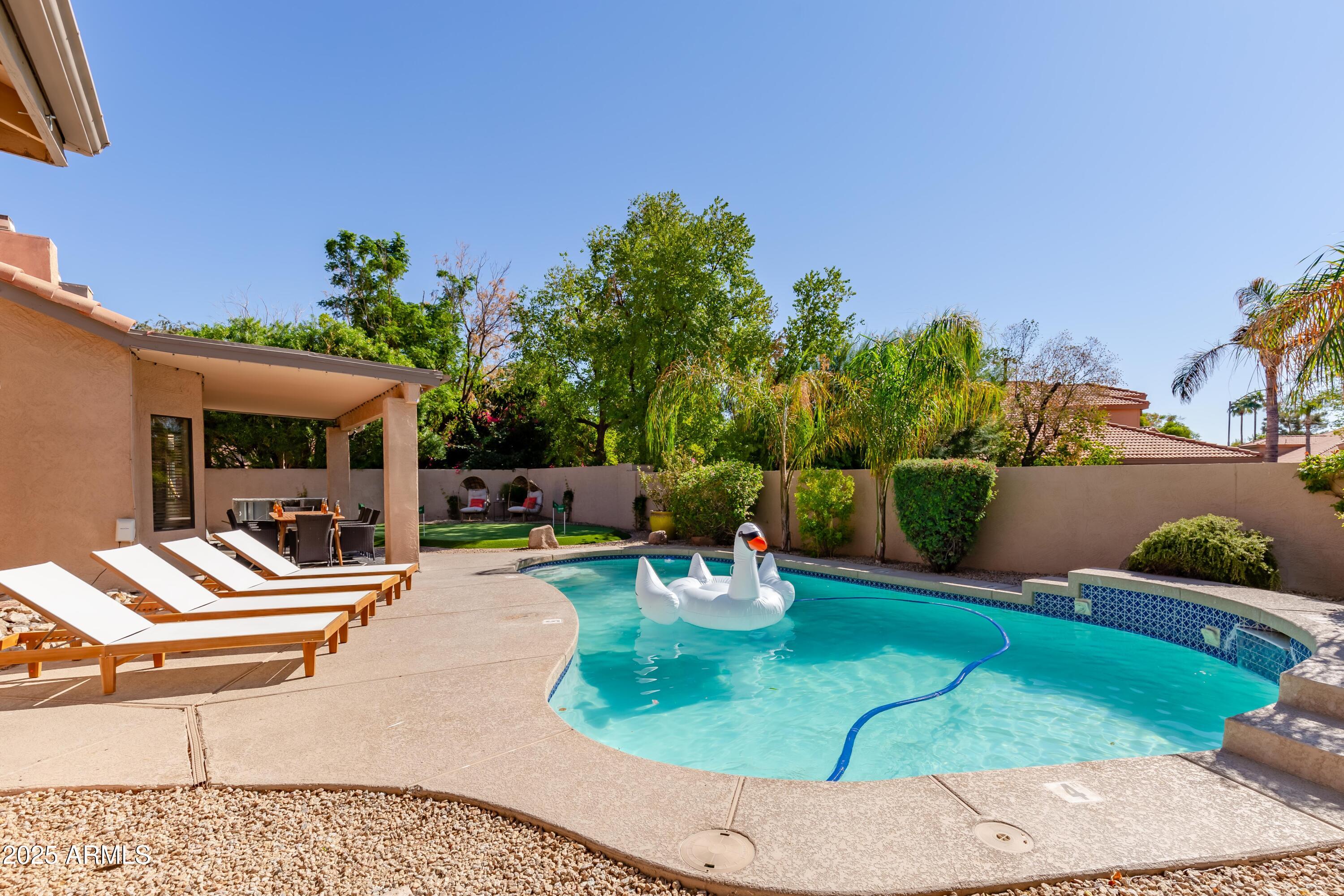 5821 East Aire Libre Avenue Scottsdale, AZ 85254 - Photo 2 of 35 a view of a chairs and table in patio
