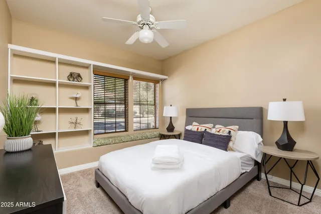 a bedroom with a large bed and a window