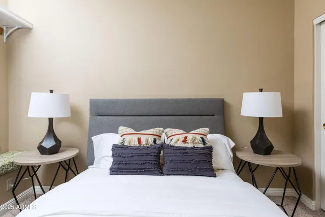 a bed room with a bed and a lamp