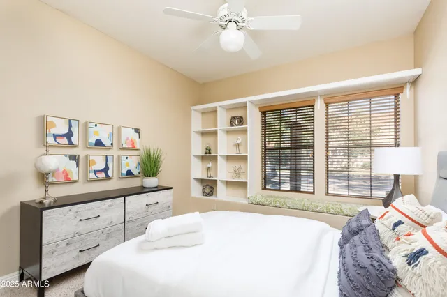 a bedroom with a bed dresser and a window