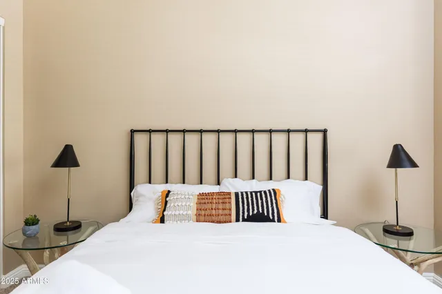 a bedroom with a bed and a lamp