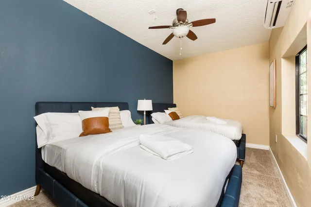 a bedroom with bed and window