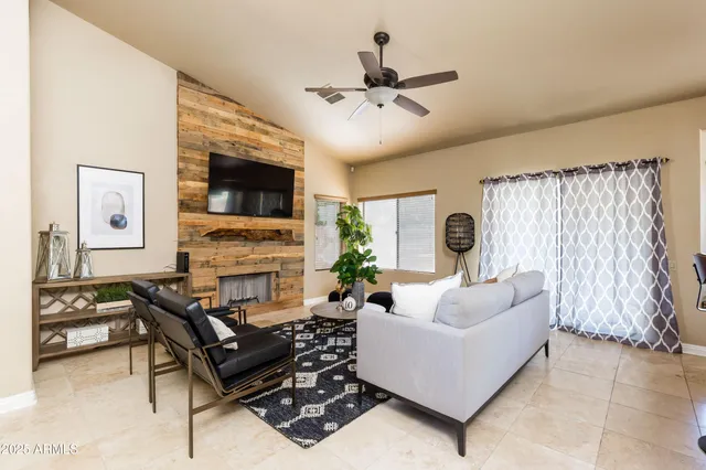 a living room with furniture and a fireplace