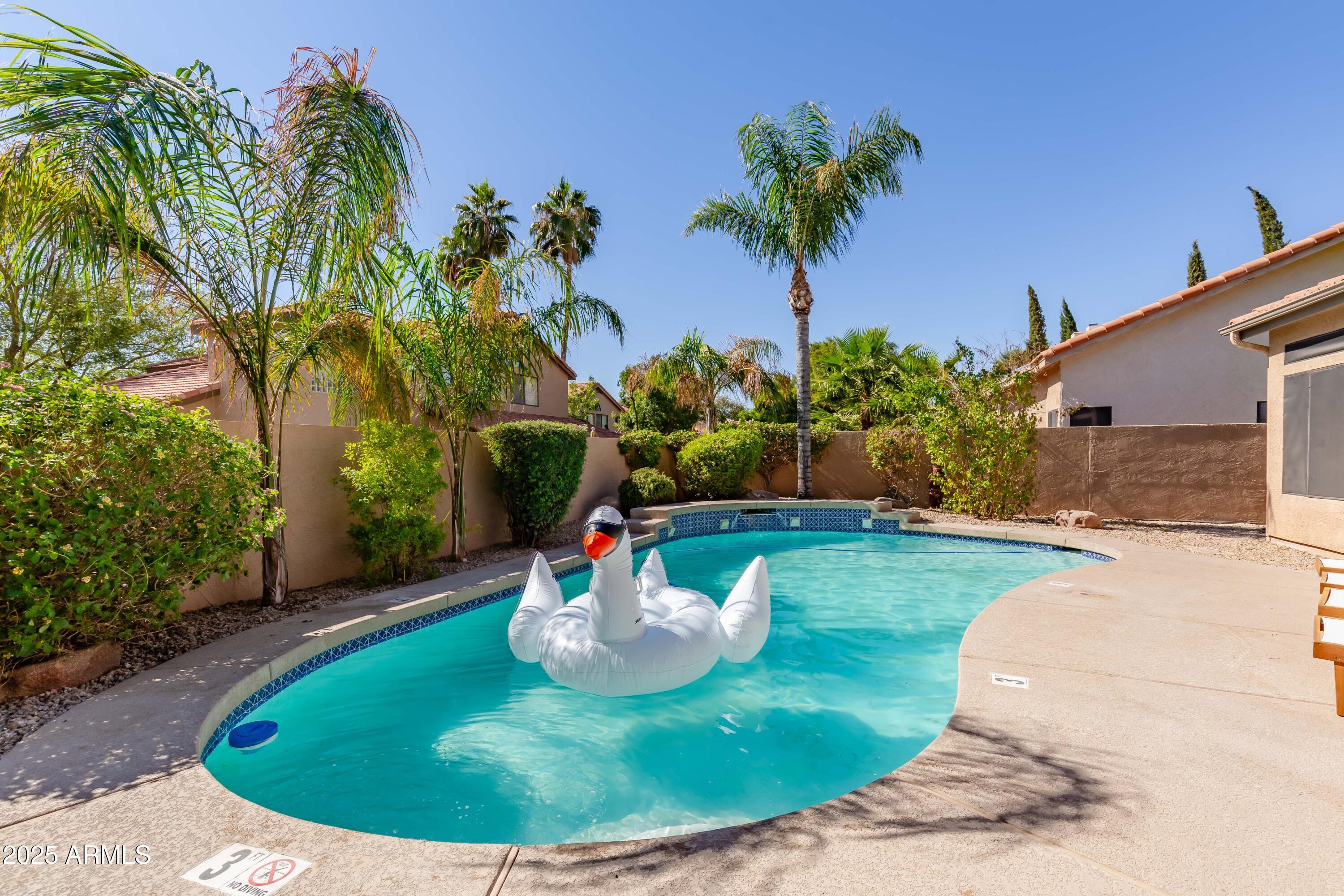 5821 East Aire Libre Avenue Scottsdale, AZ 85254 - Photo 35 of 35 a view of a swimming pool with a yard