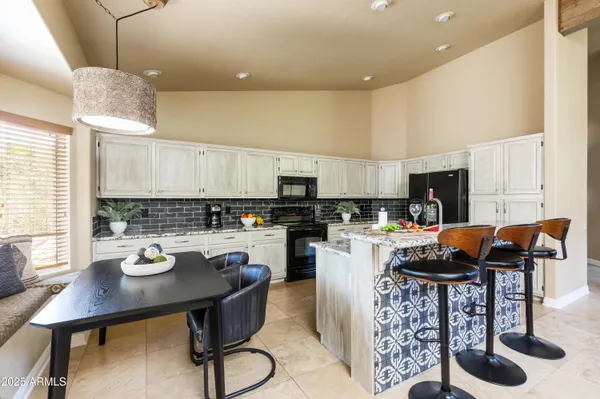 a kitchen with a table and chairs in it