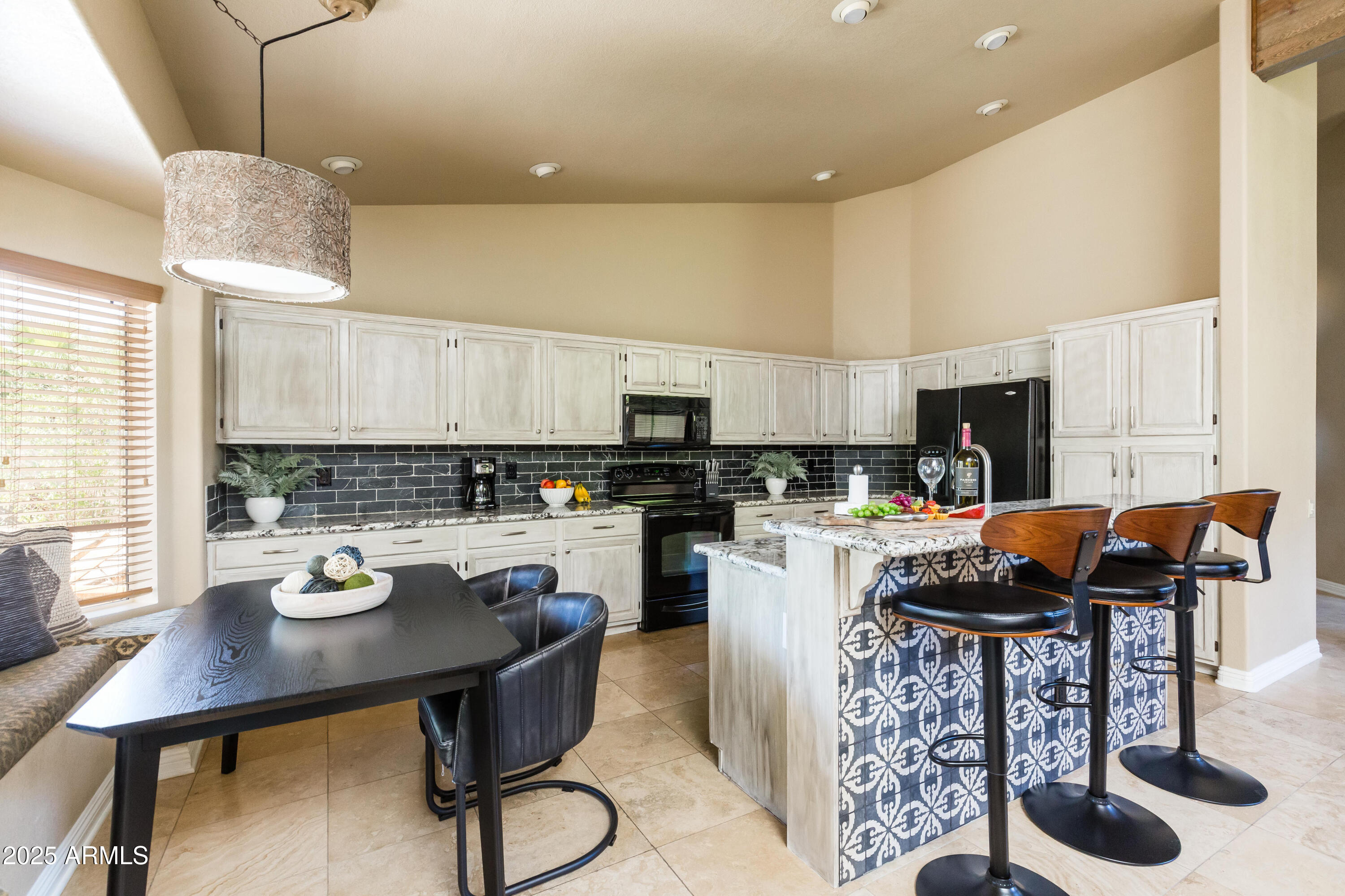 5821 East Aire Libre Avenue Scottsdale, AZ 85254 - Photo 4 of 35 a kitchen with a table and chairs in it