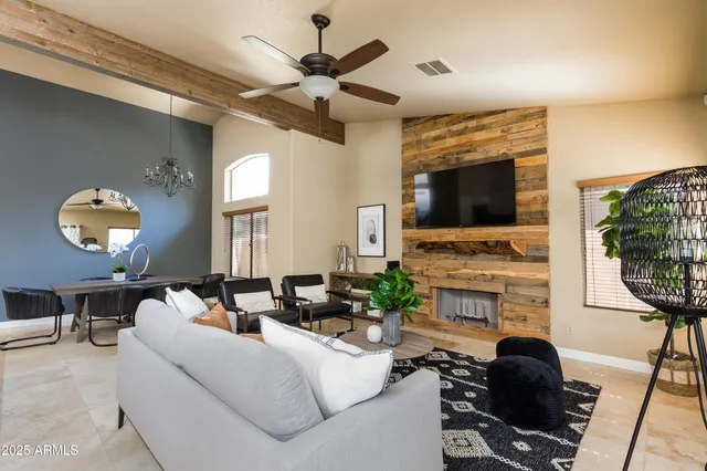 a living room with fireplace furniture and a flat screen tv