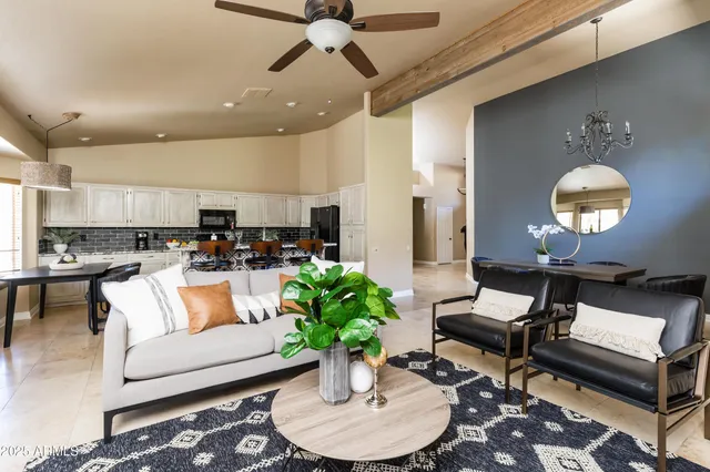 a living room with furniture and a potted plant