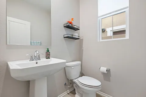 a spacious bedroom with a bed and a flat screen tv
