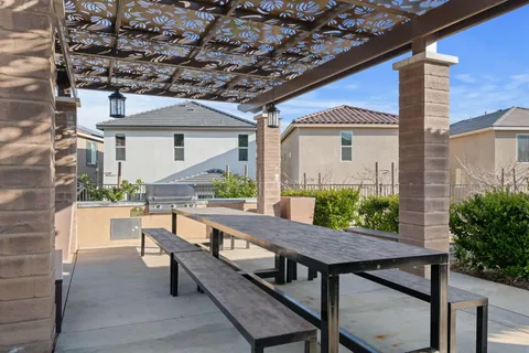 a view of a chairs and table in patio with a fire pit
