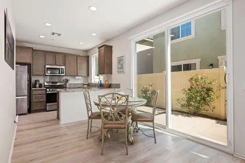 a kitchen with stainless steel appliances kitchen island granite countertop a refrigerator and microwave