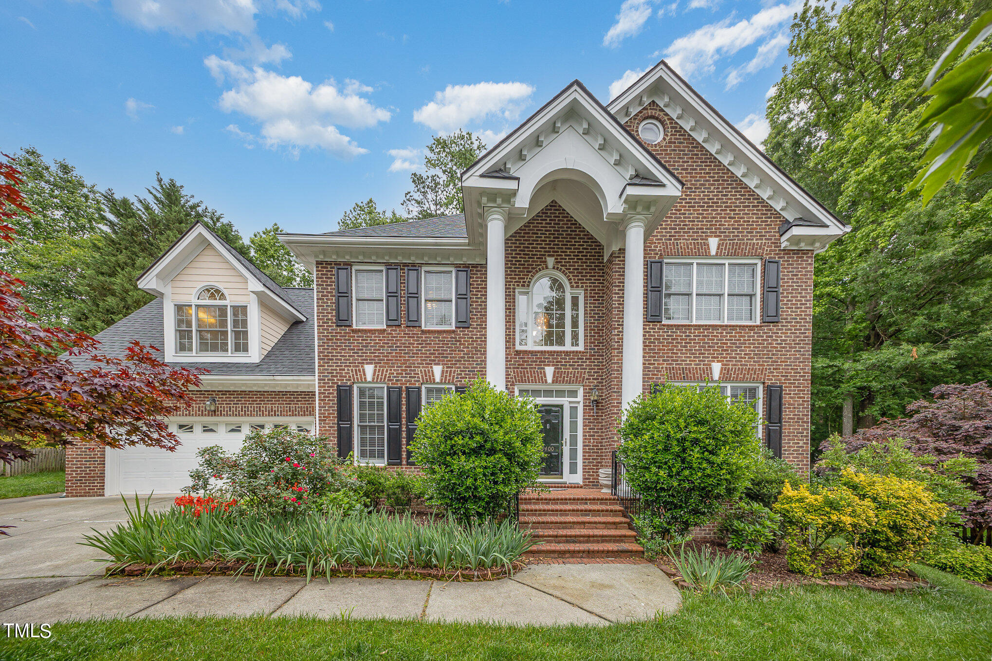 9400 Floral Ridge Court Raleigh, NC 27613 - Photo 1 of 35 a front view of a house with a yard
