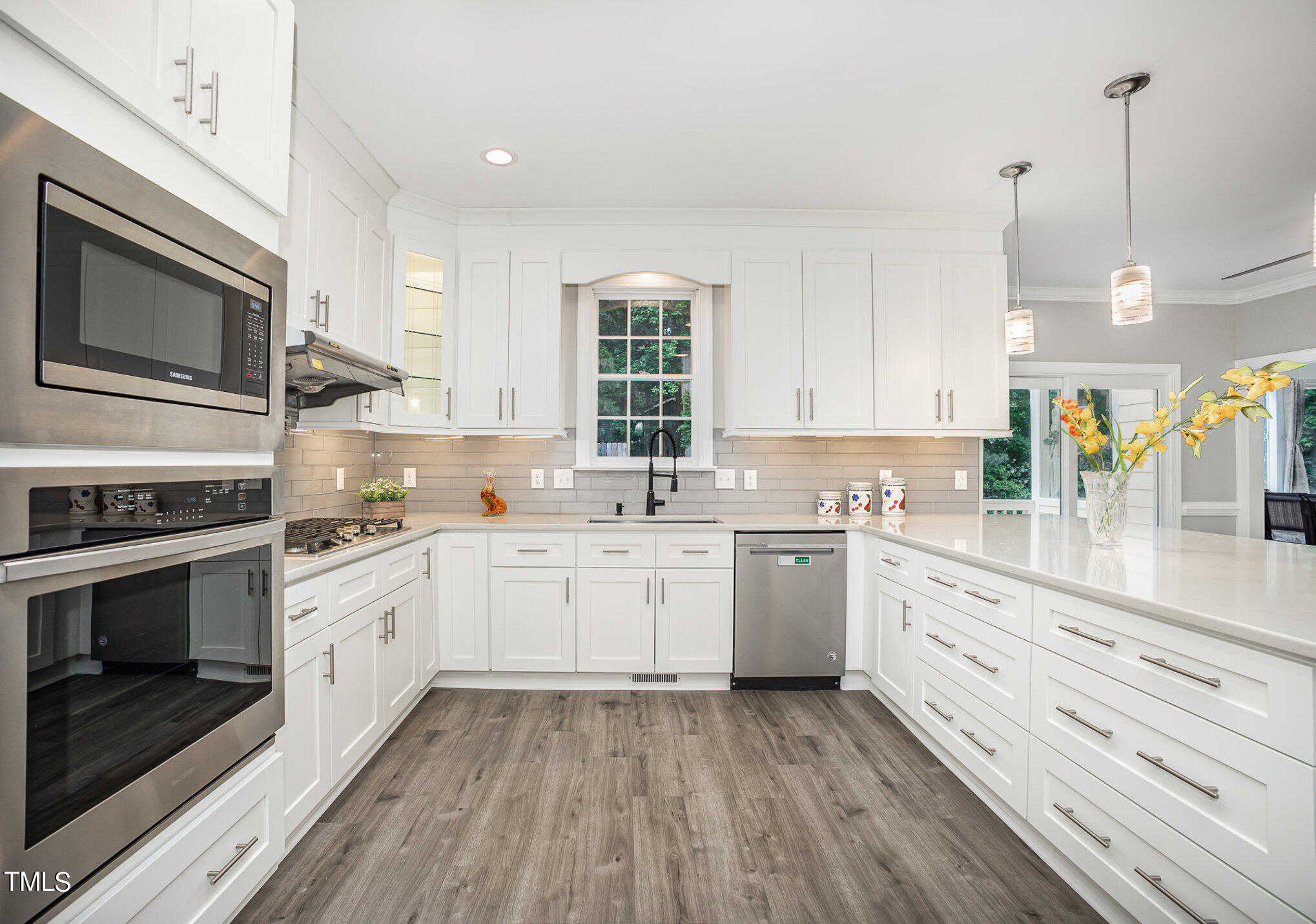 9400 Floral Ridge Court Raleigh, NC 27613 - Photo 11 of 35 a kitchen with granite countertop cabinets stainless steel appliances and a sink