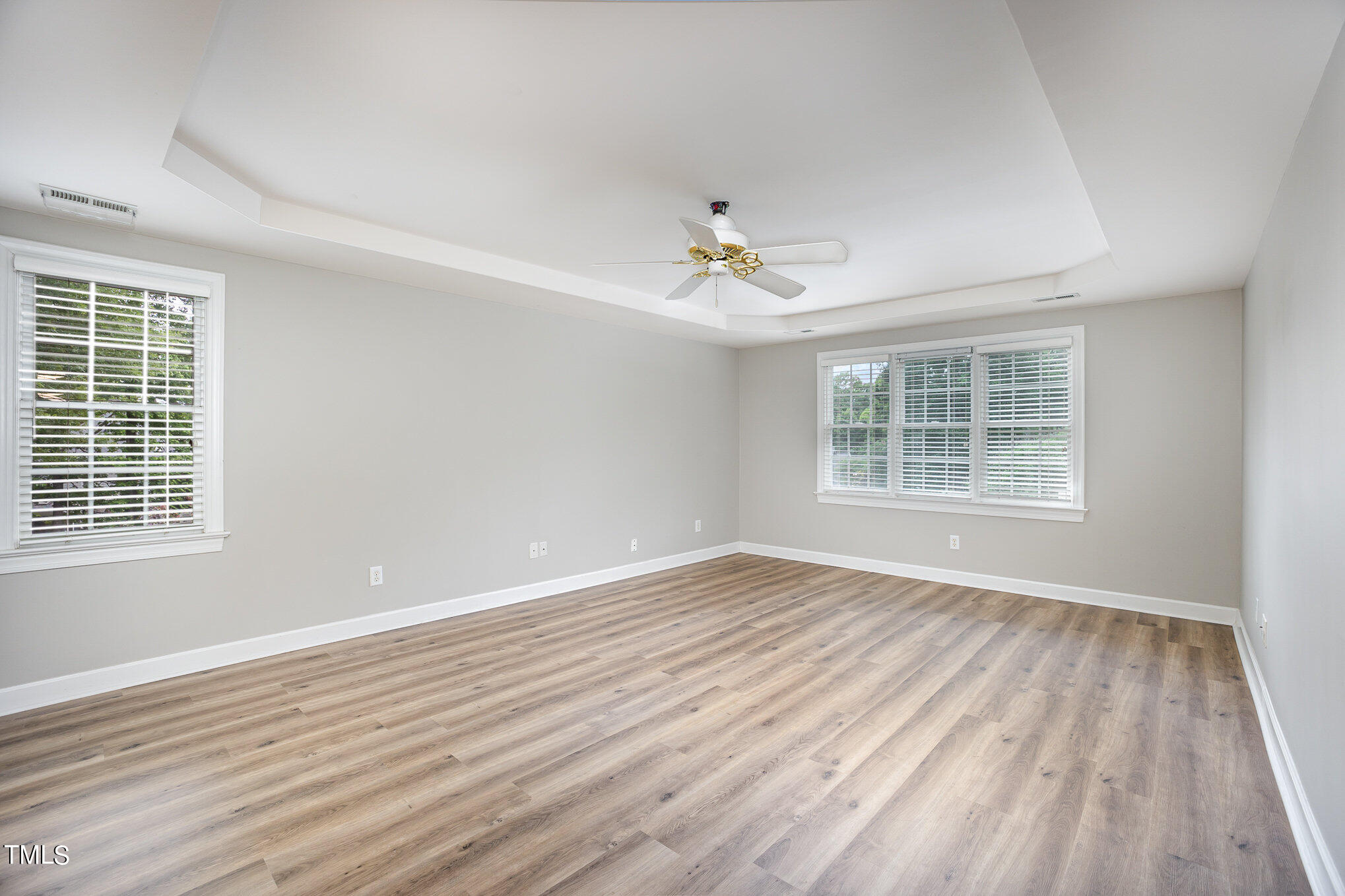 9400 Floral Ridge Court Raleigh, NC 27613 - Photo 13 of 35 a view of an empty room with wooden floor and a window