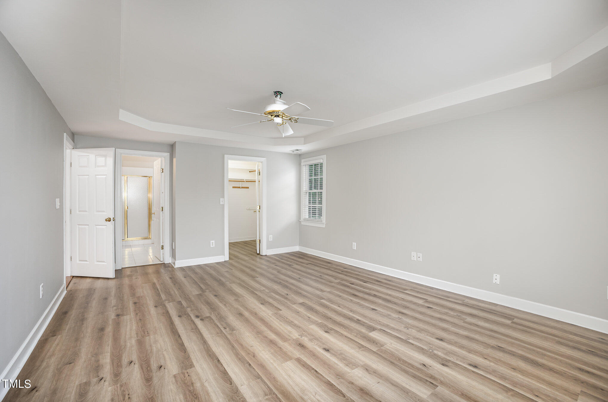 9400 Floral Ridge Court Raleigh, NC 27613 - Photo 14 of 35 wooden floor in an empty room with a window