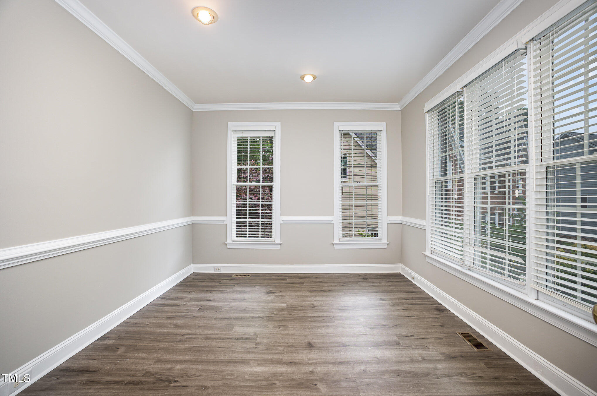 9400 Floral Ridge Court Raleigh, NC 27613 - Photo 16 of 35 a view of empty room with wooden floor and fan