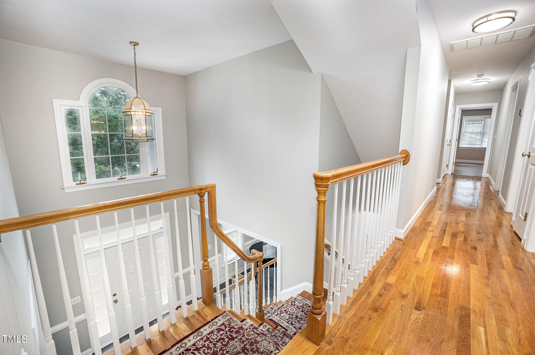 9400 Floral Ridge Court Raleigh, NC 27613 - Photo 18 of 35 a view of a hallway with wooden floor and windows