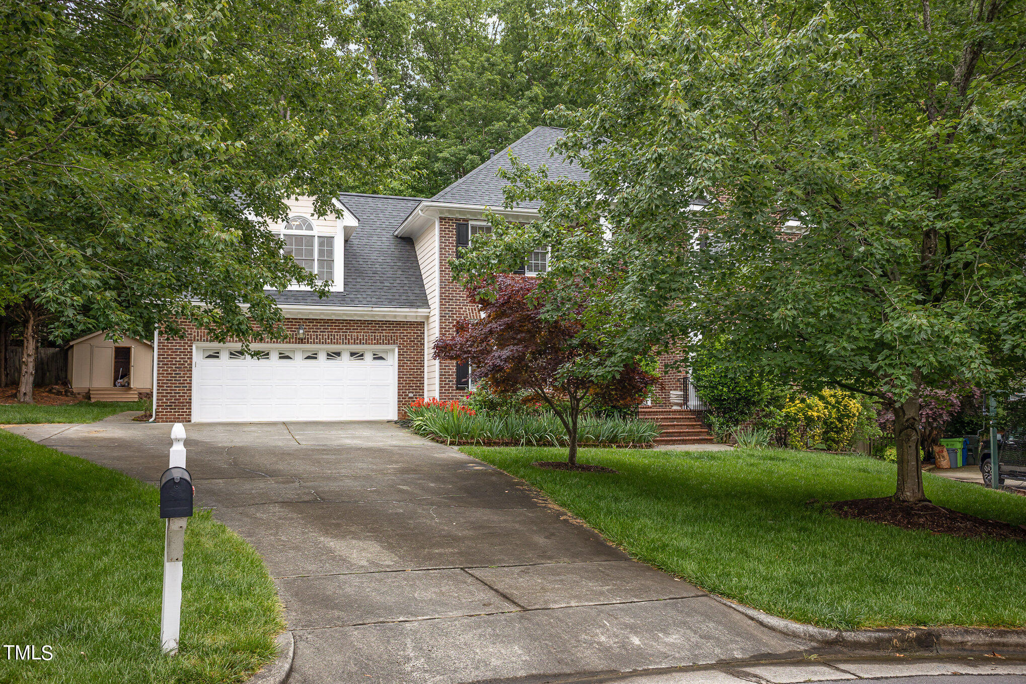 9400 Floral Ridge Court Raleigh, NC 27613 - Photo 2 of 35 a front view of a house with a yard and a garage