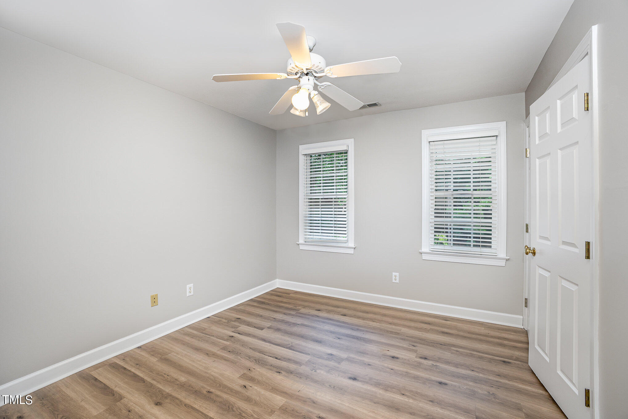 9400 Floral Ridge Court Raleigh, NC 27613 - Photo 21 of 35 a view of an empty room with wooden floor and a window