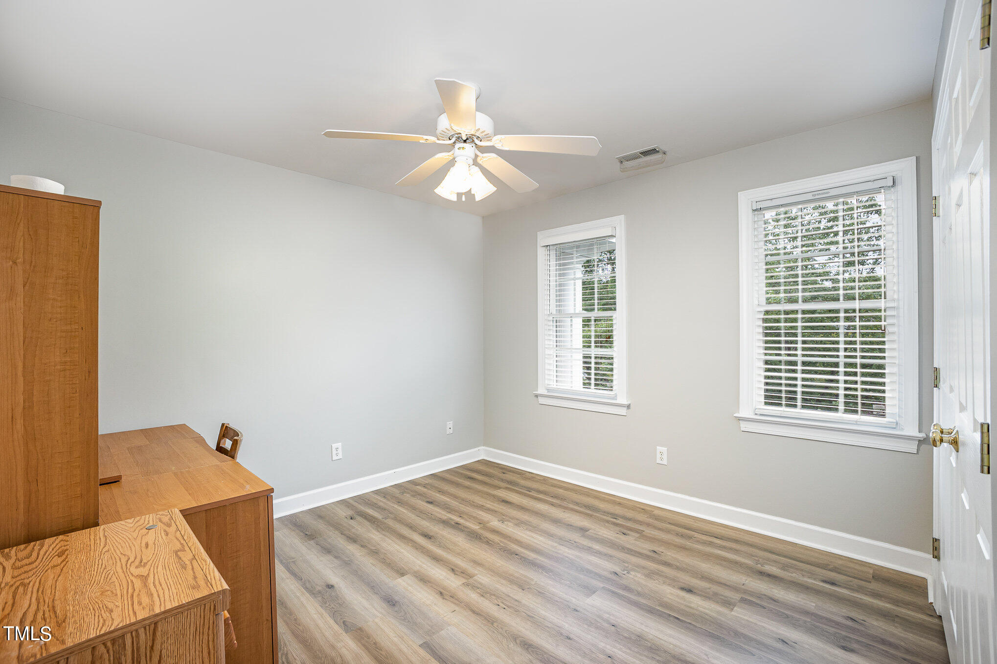 9400 Floral Ridge Court Raleigh, NC 27613 - Photo 22 of 35 a view of an empty room with wooden floor and a window