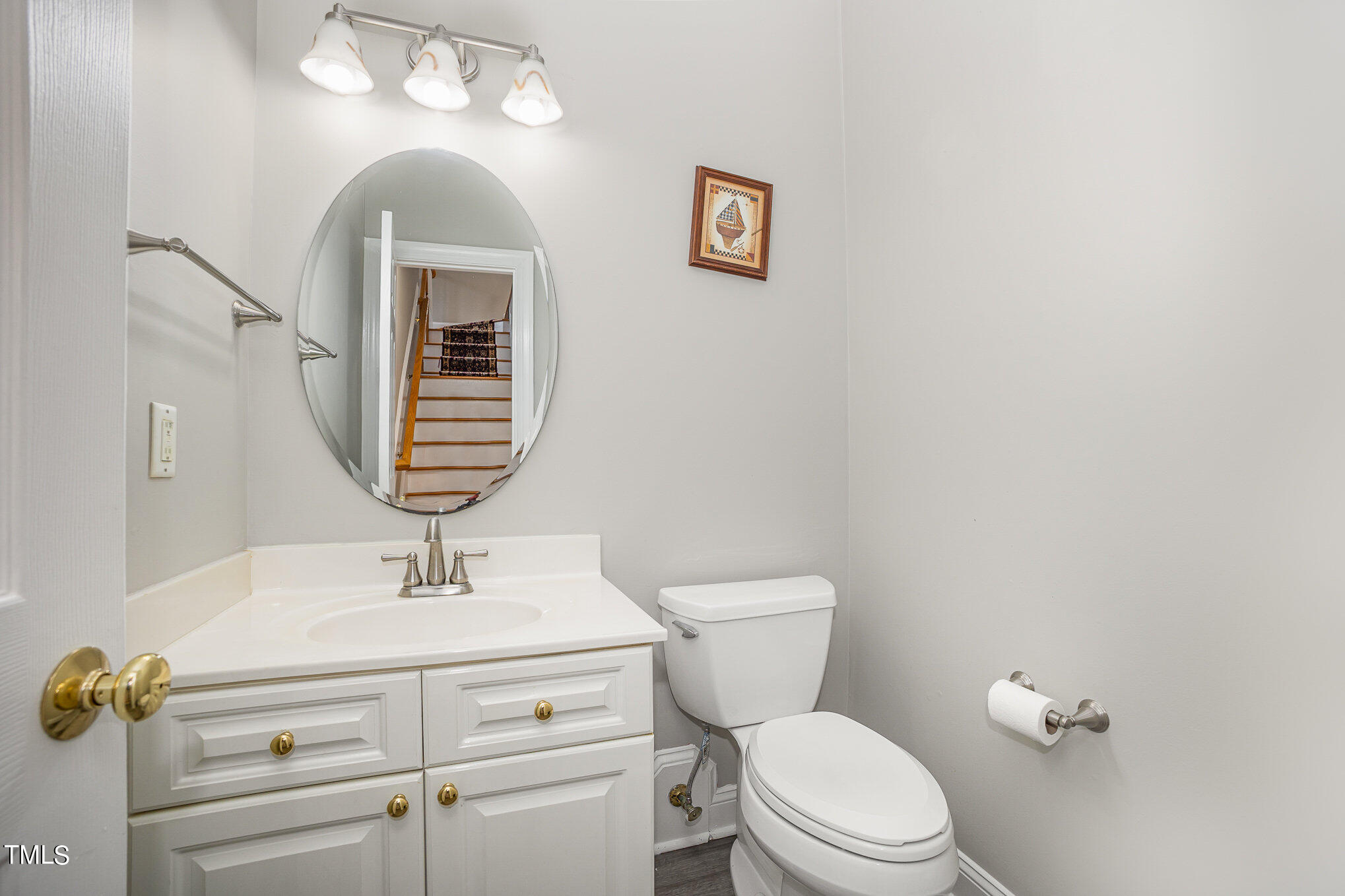 9400 Floral Ridge Court Raleigh, NC 27613 - Photo 26 of 35 a bathroom with a toilet a sink and mirror