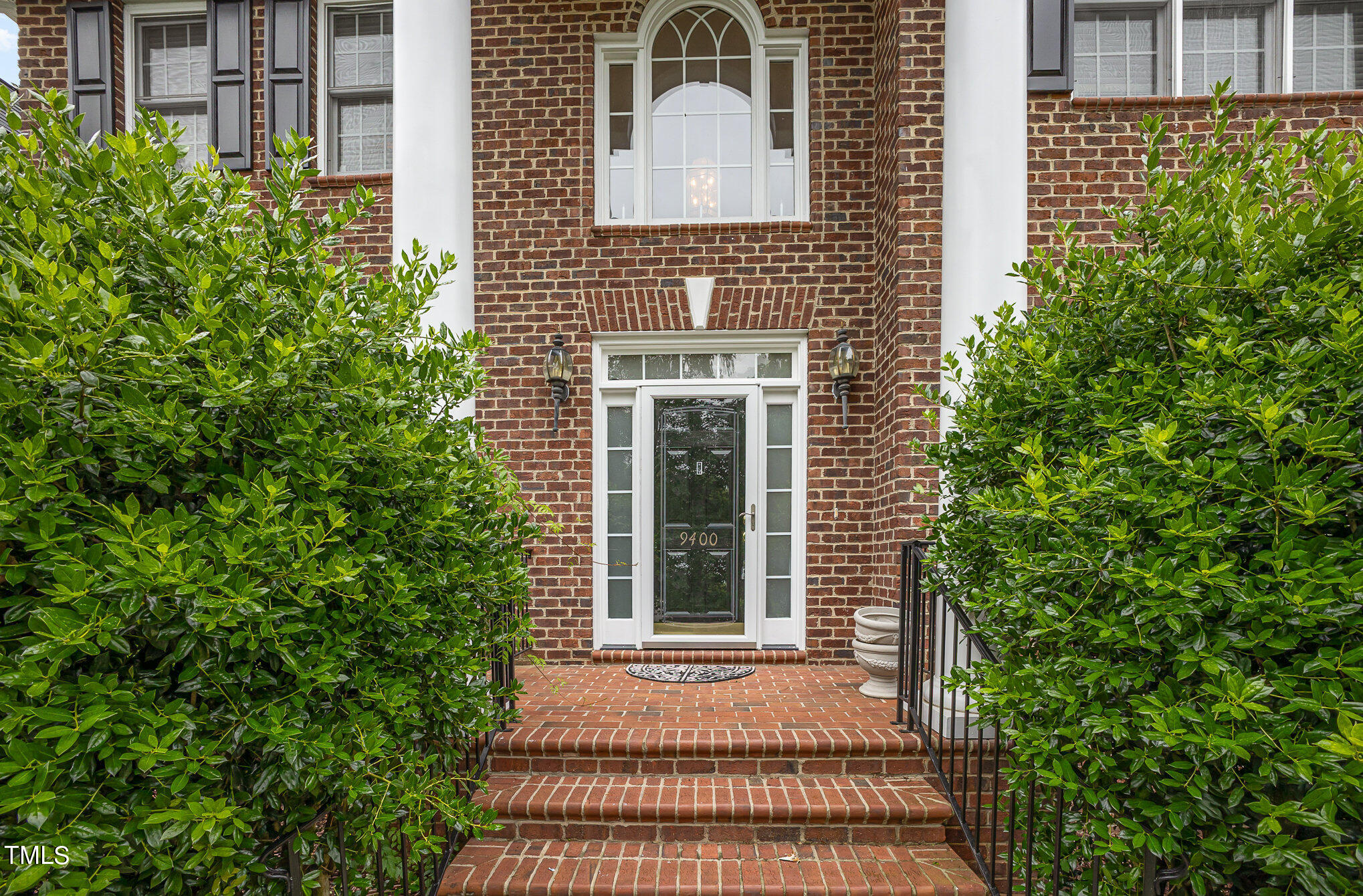 9400 Floral Ridge Court Raleigh, NC 27613 - Photo 4 of 35 a front view of a house with a yard and trees