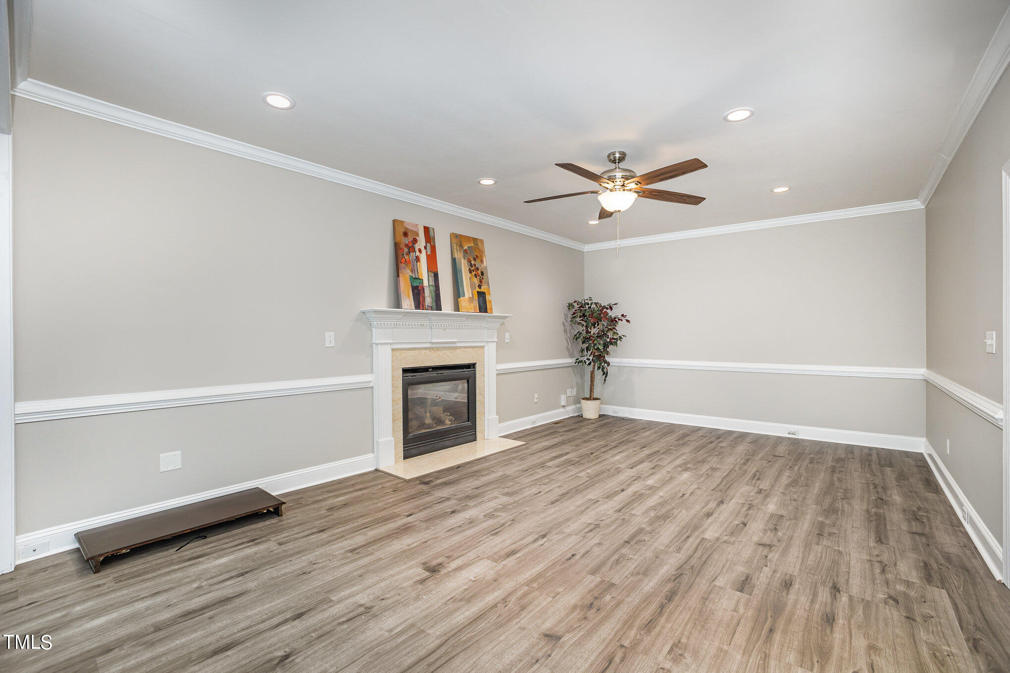 9400 Floral Ridge Court Raleigh, NC 27613 - Photo 8 of 35 wooden floor in a room with a ceiling fan
