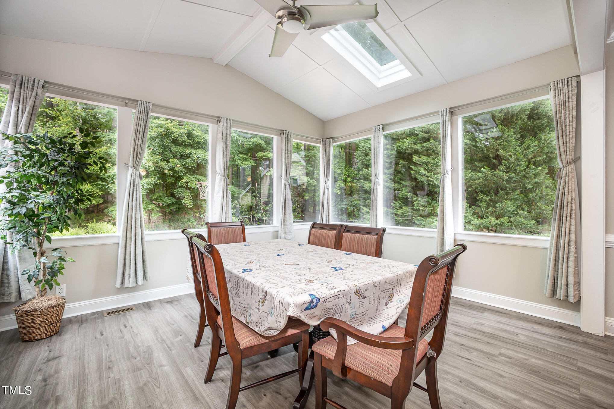9400 Floral Ridge Court Raleigh, NC 27613 - Photo 9 of 35 a view of a dining room with furniture window and wooden floor