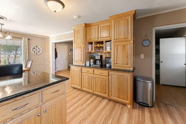 a bedroom with a bed and dresser with mirror