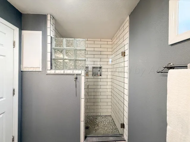 a view of a white house with a large tree