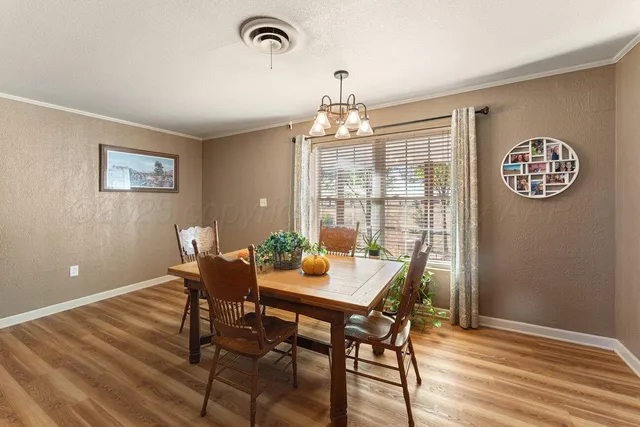 a very nice looking kitchen with a dining table and chairs