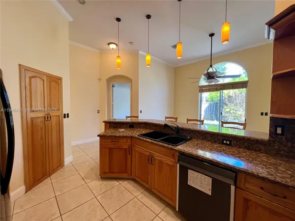 a kitchen with a sink stove and refrigerator