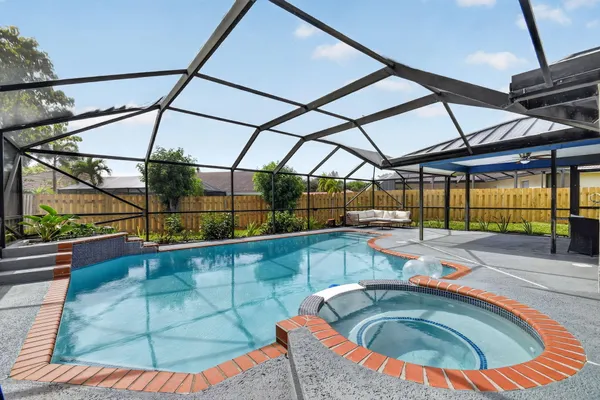 a view of a house with a yard and potted plants