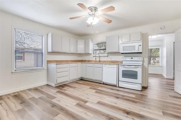 a kitchen with a stove sink and cabinets