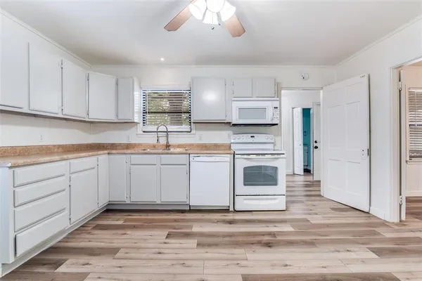 a kitchen with cabinets stainless steel appliances and a counter space