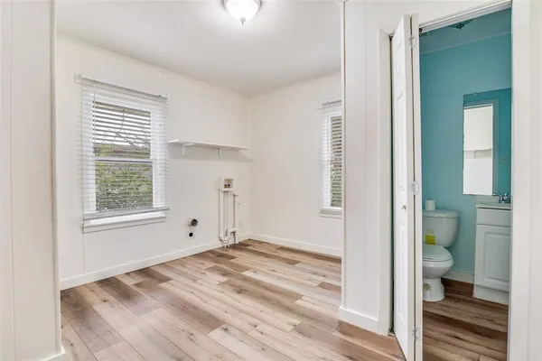 a view of wooden floor and windows in a room