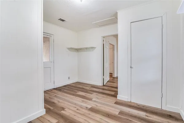 a view of a livingroom with wooden floor and closet