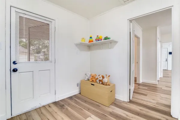 a view of a workspace with wooden floor and a potted plant
