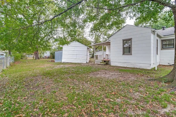 a backyard of a house with table and chairs