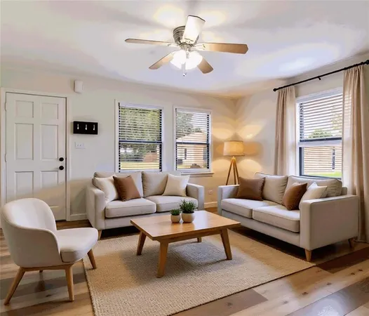 a living room with furniture a table and a large window