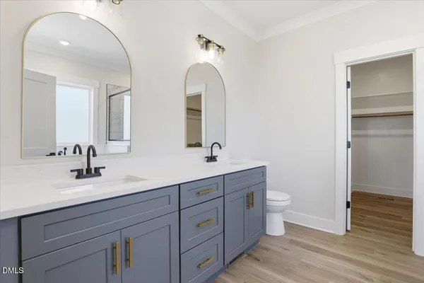 a bathroom with a double vanity sink and a mirror