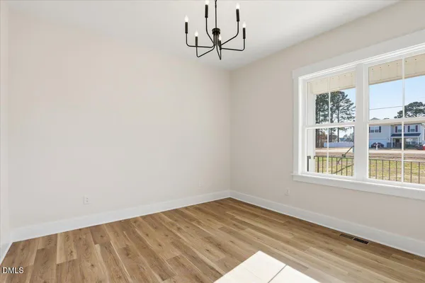 a view of a room with a window and a ceiling fan