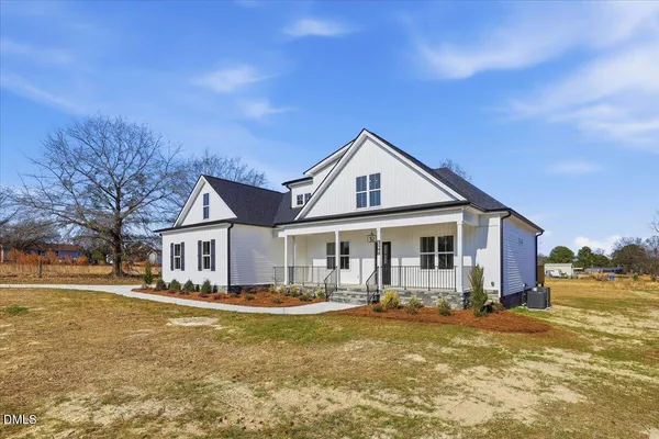 a front view of a house with swimming pool having outdoor seating