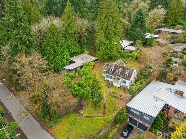 an aerial view of a house with a yard basket ball court and outdoor seating