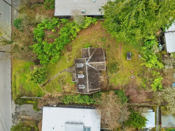 an aerial view of a house with a yard
